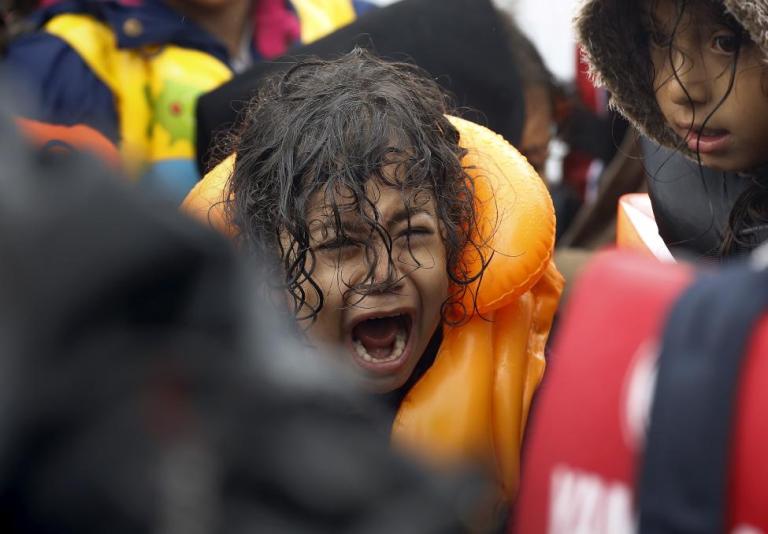 A Syrian refugee child screams inside an overcrowded dinghy after crossing part of the Aegean Sea from Turkey to the Greek island of Lesbos September 23, 2015. REUTERS/Yannis Behrakis